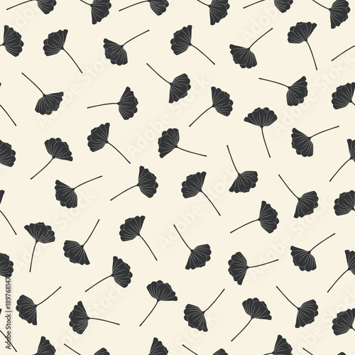 Seamless pattern of scattered dark floral silhouettes on a light beige background Vector illustration