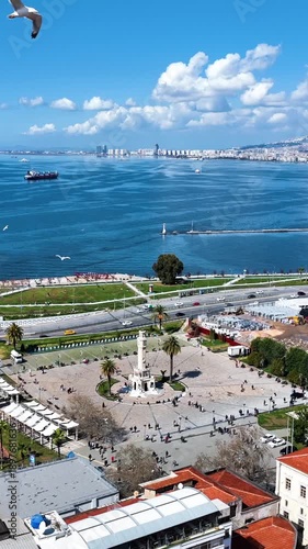 Clock tower vertical video - vertical video of the historical clock tower, the symbol of Izmir, taken with a drone
