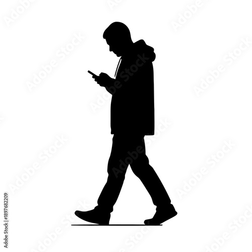 Silhouette of a man walking and using a mobile phone.