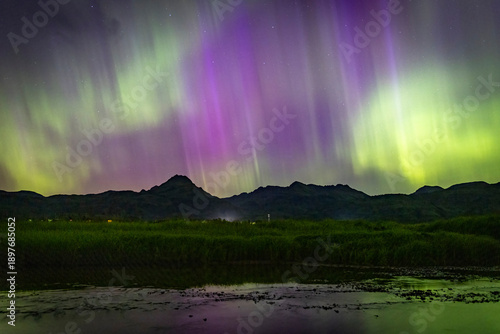 Beautiful landscape view of the northern lights over Kodiak Island in Alaska.