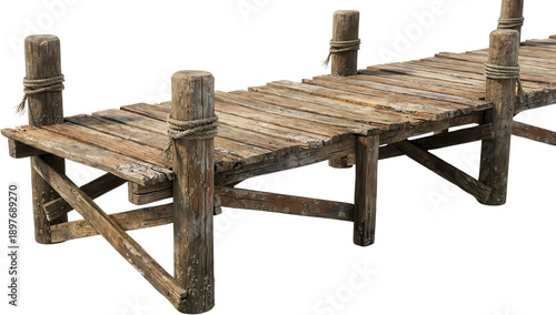 A weathered wooden pier with thick ropes tied around its supporting posts stretches into the distance dock jetty old rustic nautical maritime water sea ocean coastal beach