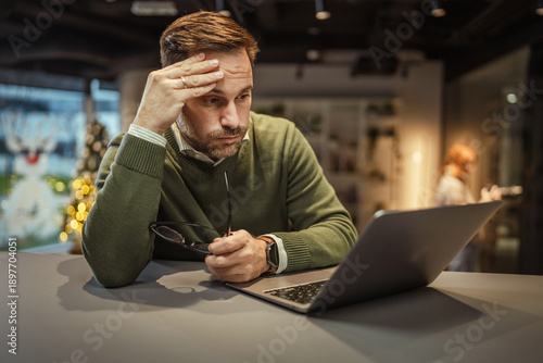 Slika na platnu Stressed businessman feeling frustrated working on laptop in office