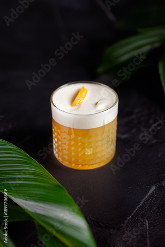 Classic whiskey sour cocktail with foam and citrus garnish
Whiskey sour served in a rocks glass at the bar
Craft whiskey sour with orange peel and frothy top