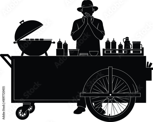 Black silhouette vector of a male street food vendor in a hat standing behind a mobile grill cart with condiments for outdoor catering concepts
