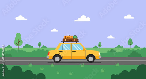 Yellow car driving on a road with luggage on the roof in a scenic landscape.
