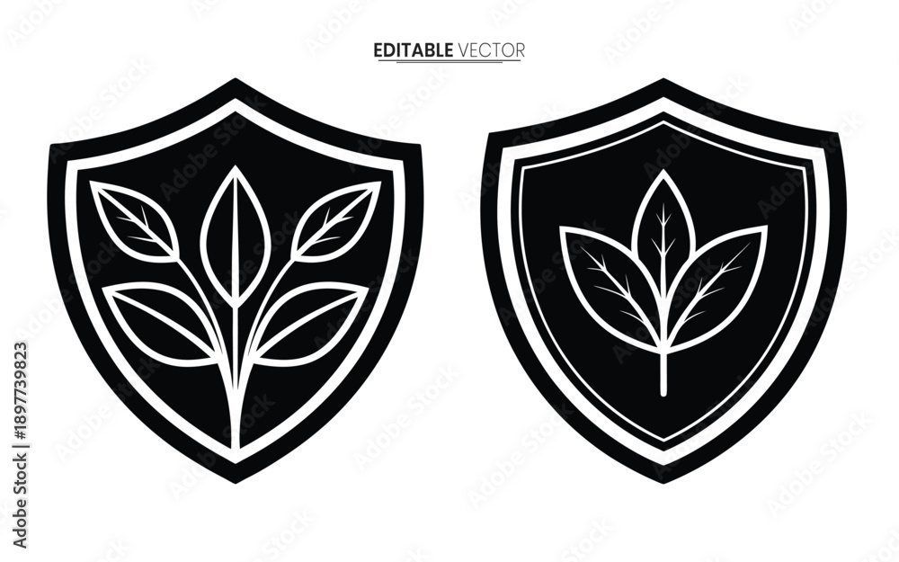 Fototapeta premium Two black shield emblems featuring stylized leaf designs presented as editable vector graphics high quality