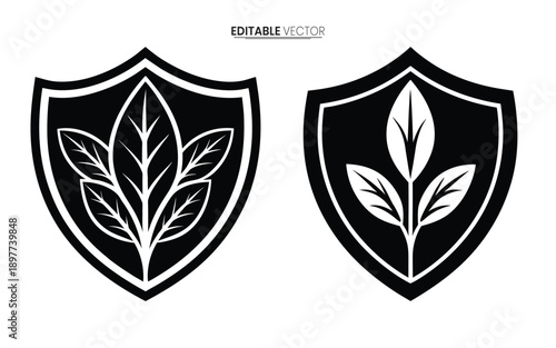 Two black shields with stylized leaf designs a vector illustration for heraldry or branding