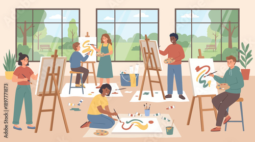 Group of people engaging in a creative painting activity together in a well-lit studio.