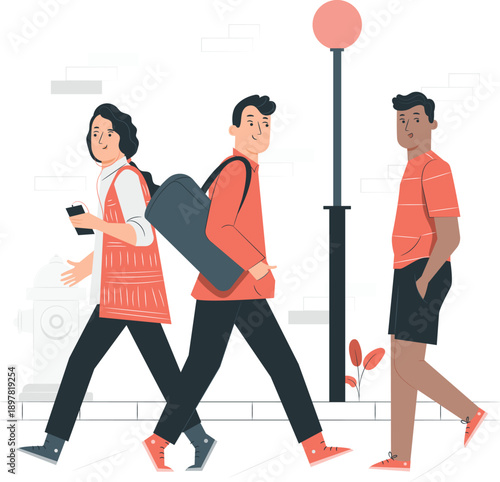 Three people walking in different directions on a street with a streetlight