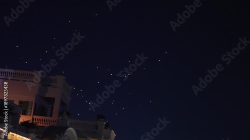 Wallpaper Mural Performative drones light up the night sky, forming glowing patterns high above the city during a nighttime light show. Torontodigital.ca