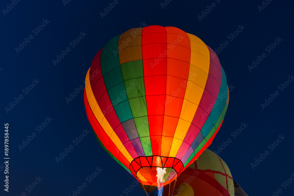 Fototapeta premium colorful hot air balloons glowing against the night sky