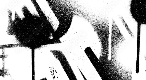 Abstract black and white spray paint texture on a wall.