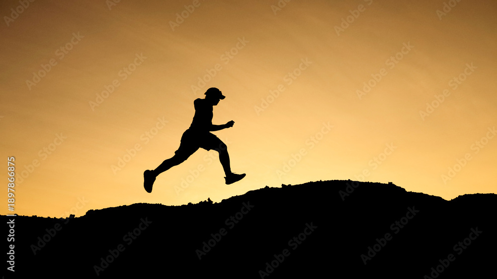 custom made wallpaper toronto digitalSilhouette of a runner mid-air against an orange sky background. Showcasing determination and the pursuit of a goal. The individual is in motion
