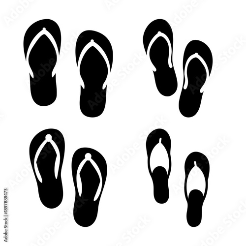 An assortment of black flip-flops with white straps arranged casually on a plain background