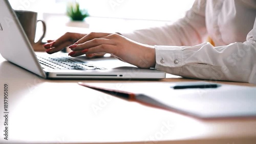 Man hands typing on keyboard of silver laptop performing work, filling out online forms or writing business letter. Close-up