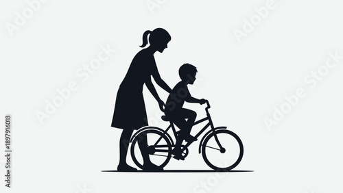 Mother teaching her young child to ride a bicycle.