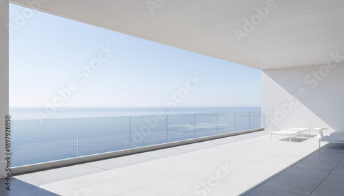 Modern oceanfront balcony with glass railing and minimalist furniture