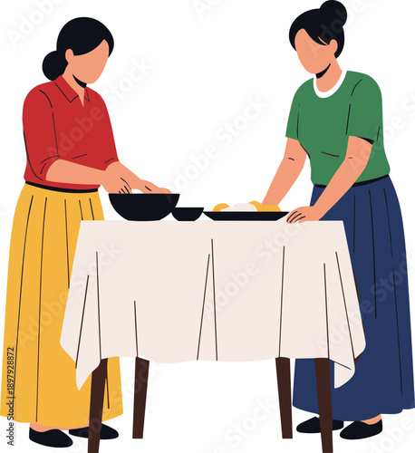 Two women preparing food at a table with a tablecloth serving
