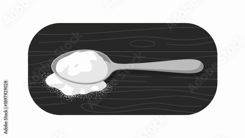 Spoon holding white powder on a dark wooden surface with scattered grains