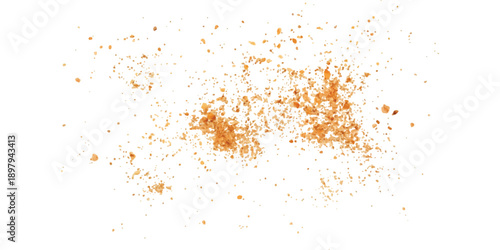 A close-up view of irregularly scattered orange particles, resembling fine powder or spice, isolated on a white background.