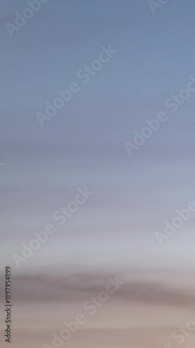 Evening sky time-lapse capturing the shift from sunset glow to nighttime darkness with subtle cloud movement.
