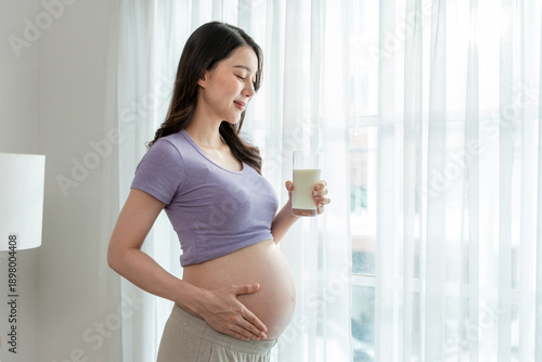 Asian beautiful pregnant woman drink a glass of milk for prenatal health. Free Download Asian beautiful pregnant woman drink a glass of milk for prenatal health. - GFXLoad