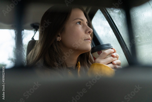 Canvas Print Woman traveling in car contemplating rainy day