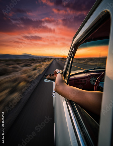 Carefree Desert Highway Adventure With Arm Extended From Classic White Convertible During Spectacular Sunset