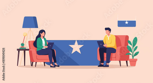 People working on laptops in a modern living room with a national flag