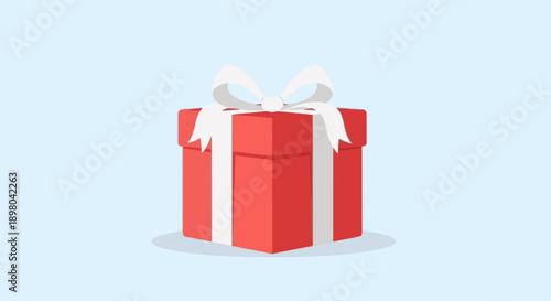Red gift box with white ribbon and bow against a light blue background