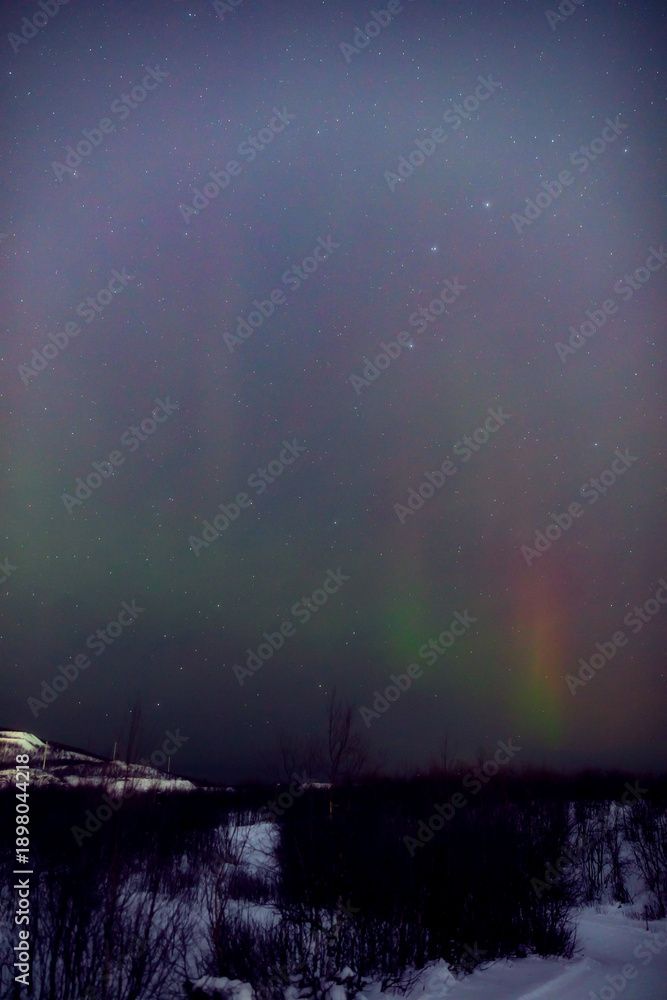 Fototapeta premium Aurora borealis, polar lights with Milky Way stars.