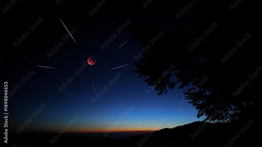 Fototapeta premium Blue hour time with lunar eclipse, stars and planets above landscape silhouettes.