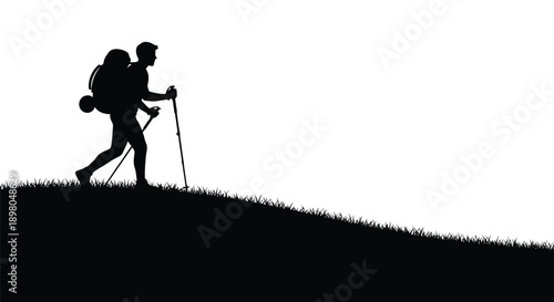 Silhouette of a hiker ascending a grassy hill with trekking poles