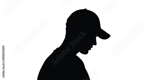 Silhouette of a man wearing a baseball cap in profile view
