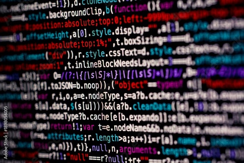 A dynamic close-up photograph of colorful programming code on a dark monitor screen, representing modern web development, cybersecurity, and advanced technology concepts