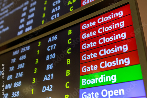 Close-up view of an airport departure information board displaying flight boarding status, gate opening, gate closing, and last call notices at a Airport.