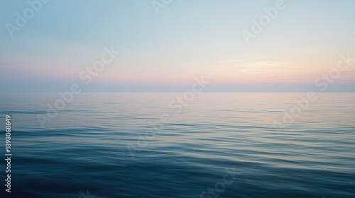 Calm ocean horizon background with soft pastel sky and minimal copy space.