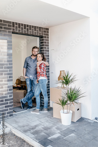Wallpaper Mural Happy couple standing in door of their new home Torontodigital.ca
