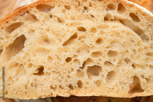 Close-up texture of homemade artisan sourdough bread. Macro photography of a slice of bread. Food background