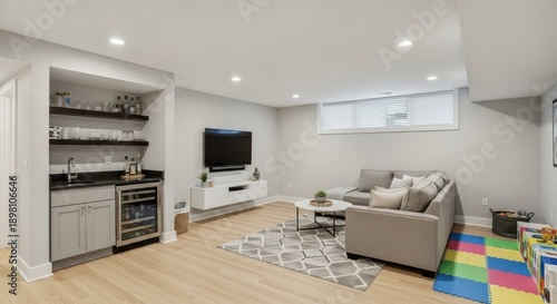 Modern living room with bar area, sofa, TV, and children's play mat