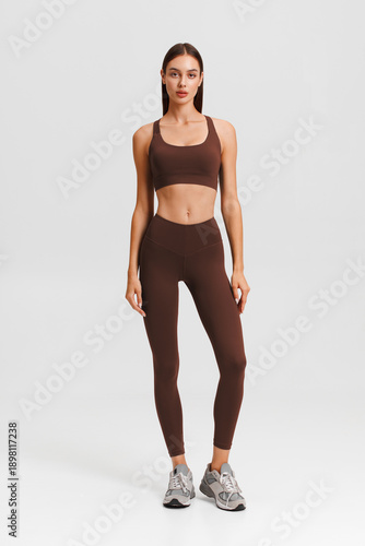 Athletic girl on the gray background. Fitness woman