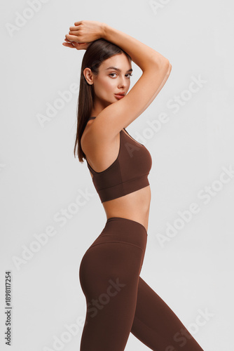 Athletic girl on the gray background. Fitness woman