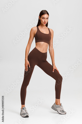 Athletic girl on the gray background. Fitness woman