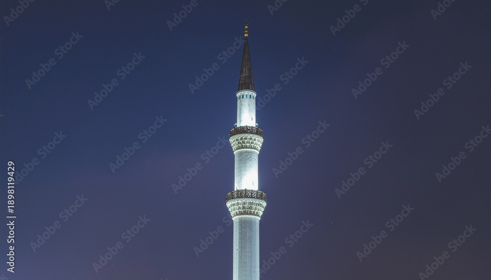 Obraz premium Minimalist Geometric Minaret. Islamic Culture – Building and Architecture. A high-contrast, architectural photograph of a single, stark white minaret with a sleek, minimalist geometric design. 