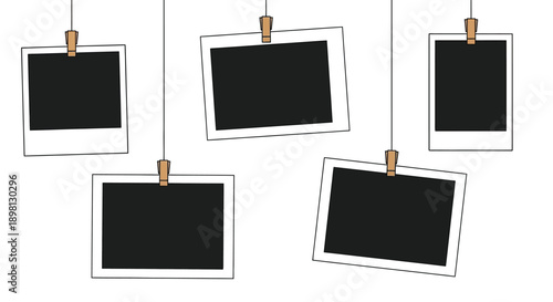 Hanging blank photo frames suspended by strings and wooden clips