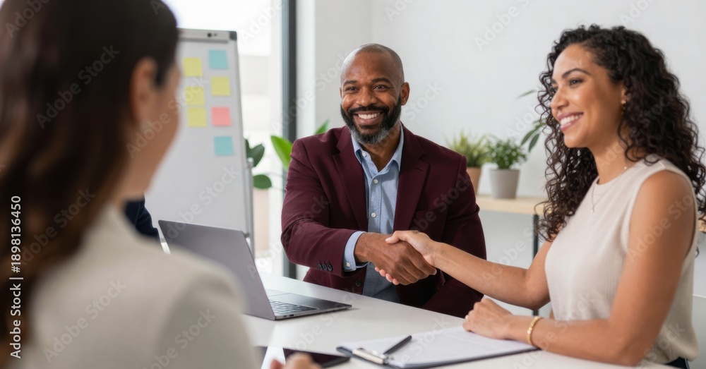 Fototapeta premium Successful job interview: Candidate shaking hands with hiring manager, welcoming new employee, expressing confidence and professionalism