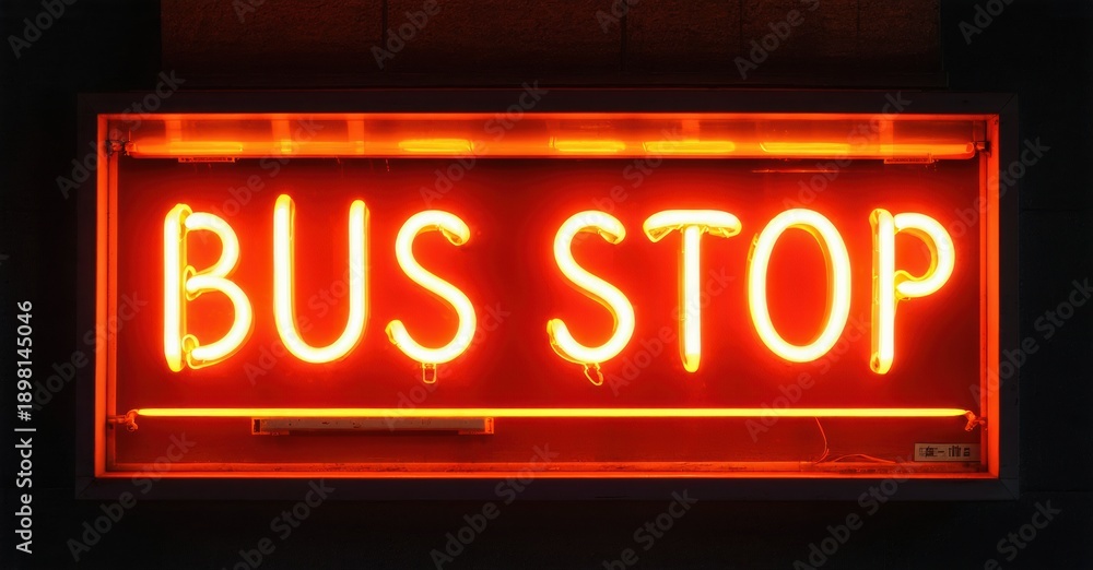 Obraz premium Bright neon sign displays BUS STOP. Rectangular frame glows orange against dark background. Simple, direct messaging.