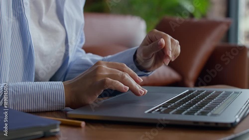Hands Browsing Online on Laptop at Home