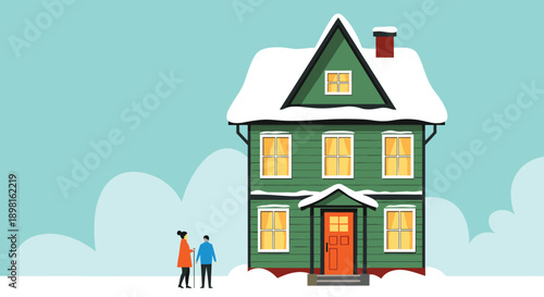 Cozy two story green house in a winter landscape with snow covered roof and two people standing outside on a cold and cloudy day.