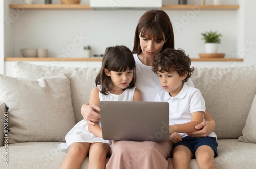 Mother and children using laptop at home together, enjoying quality family time, screen watching
